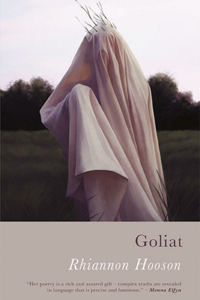 This cover shows a photograph of a figure shrouded in a sheet standing in the middle of a deserted field. The text reads: Goliat. Rhiannon Hooson.