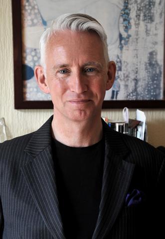 Graham Davies is a white man with short hair. He is wearing a dark t-shirt and jacket.