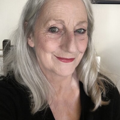 Photo of Jo Mazelis. She is smiling at the camera and is wearing a black top.