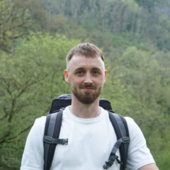 Photo of Jamie Hill standing outside and smiling at the camera