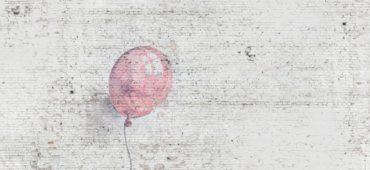 Photo of a single baby pink balloon painted on a white bright wall