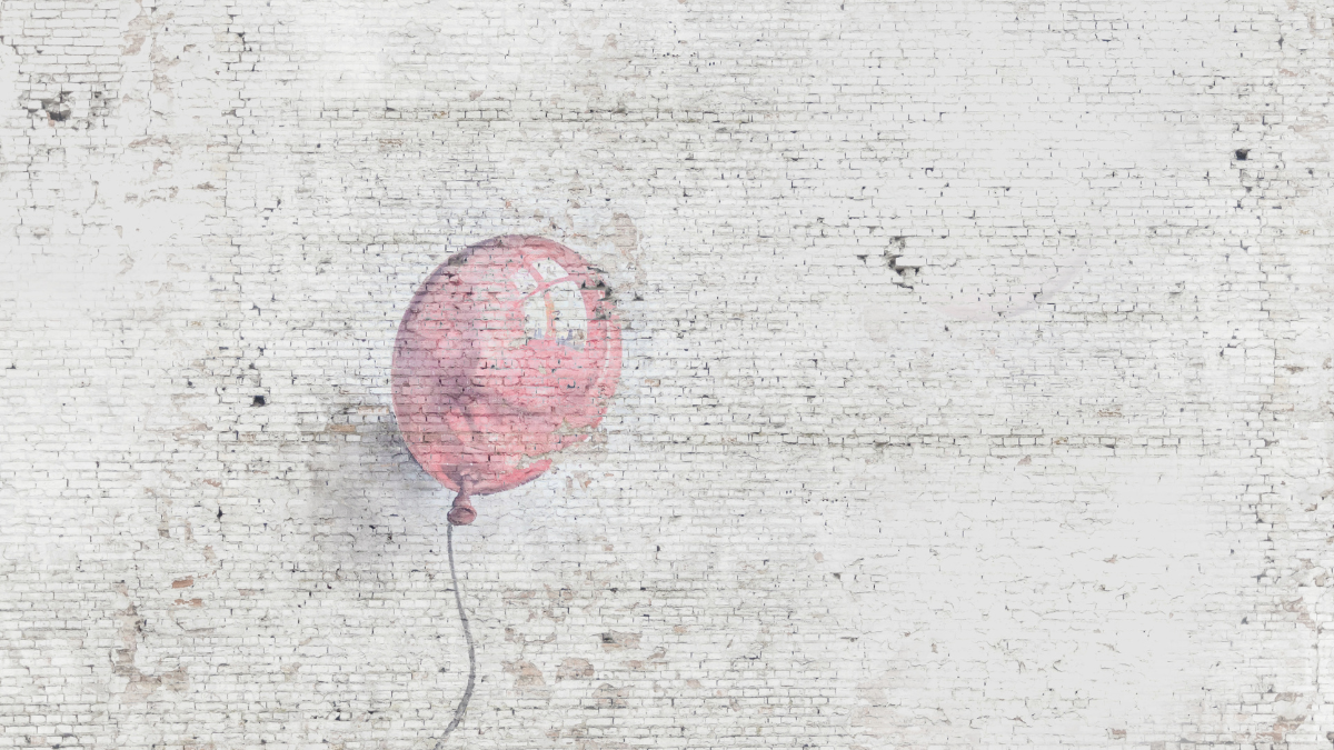 Photo of a single baby pink balloon painted on a white bright wall