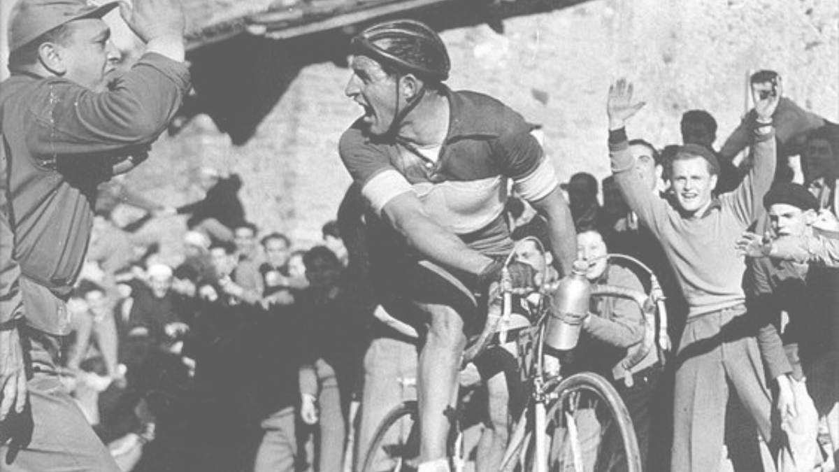This cover shows a colour photograph of cyclist Gina Bartali riding through a cheering crowd.