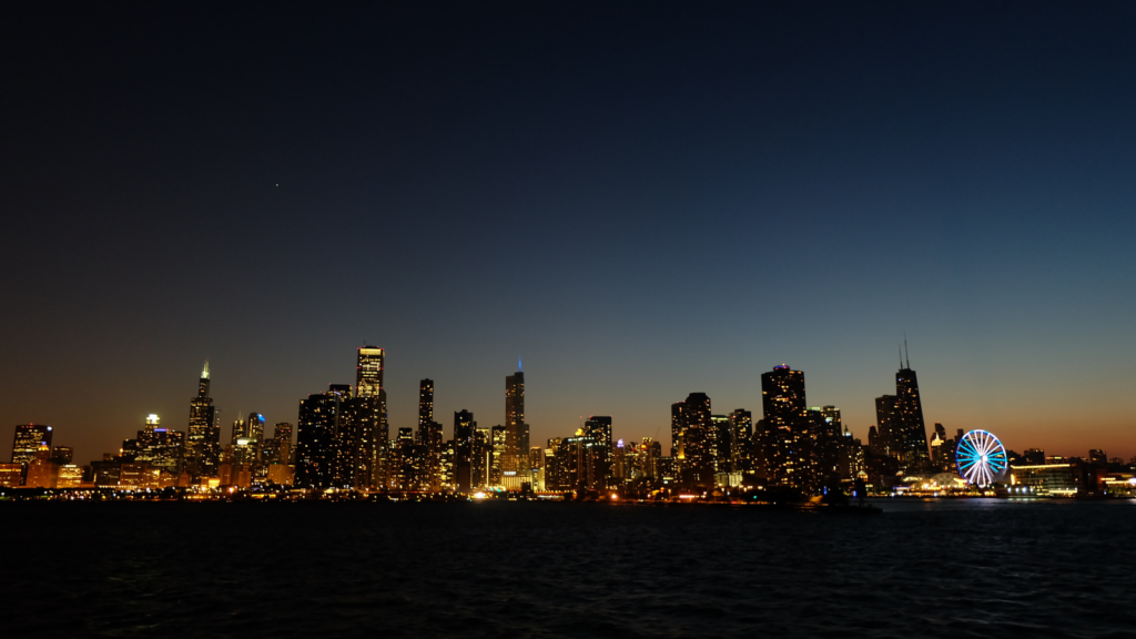 Photo of a city skyline lit up against the dark night sky