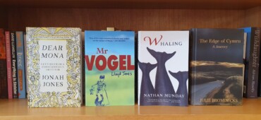 Copies of Dear Mona, Mr Vogel, Whaling and The Edge of Cymru standing face out on a bookshelf