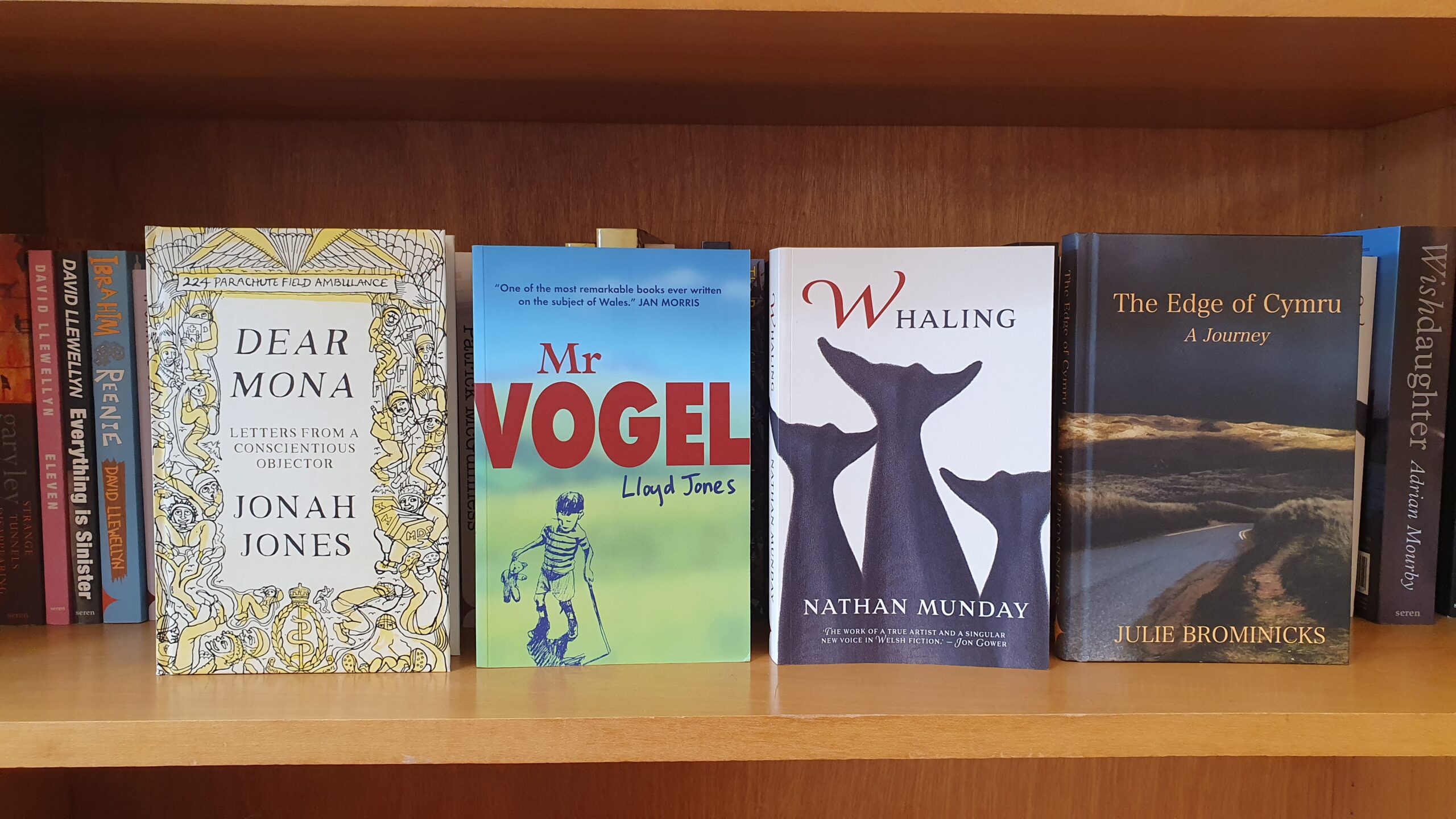 Copies of Dear Mona, Mr Vogel, Whaling and The Edge of Cymru standing face out on a bookshelf