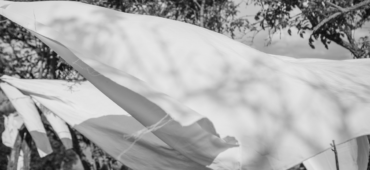 Black and white image of laundry blowing in the wind on a washing line