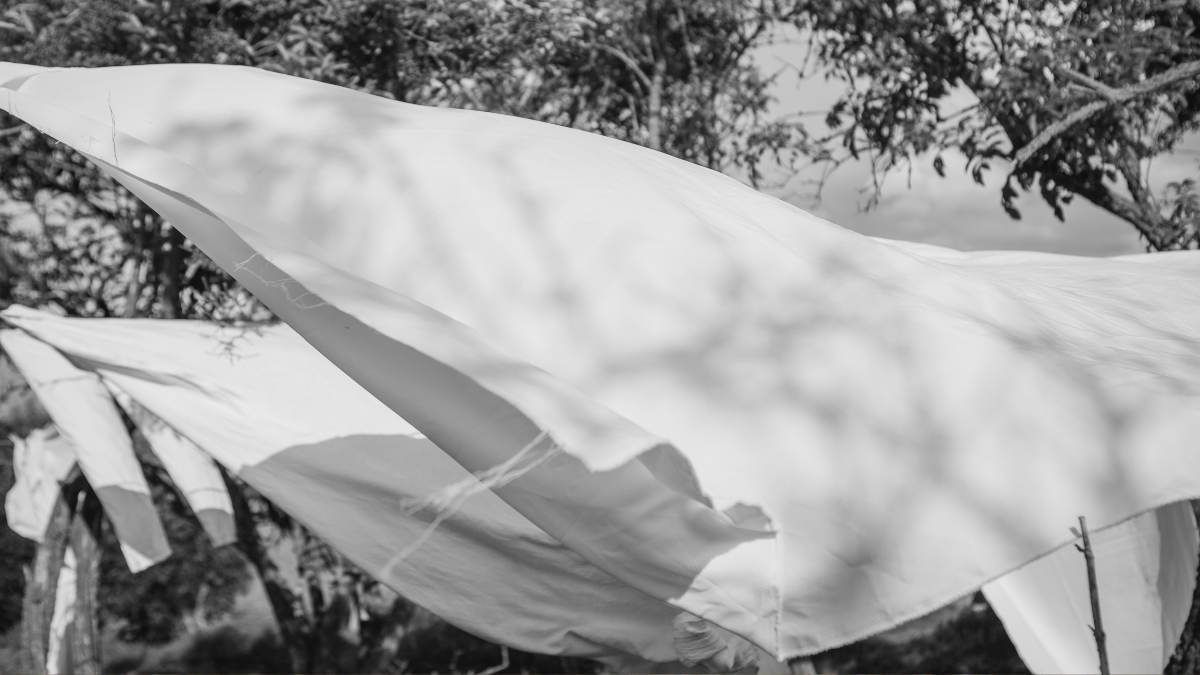Black and white image of laundry blowing in the wind on a washing line
