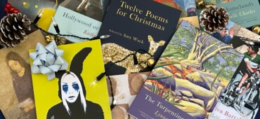 Photograph of lots of Seren poetry titles including Republic, Twelve Poems for Christmas and The Turpentine Tree lying in a scattered pile surrounded by festive decorations.
