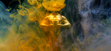 An Oscar award hidden behind clouds of coloured smoke