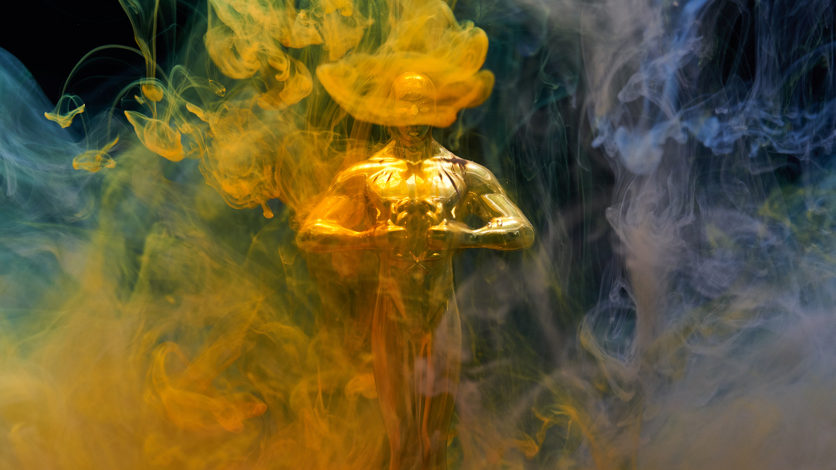 An Oscar award hidden behind clouds of coloured smoke