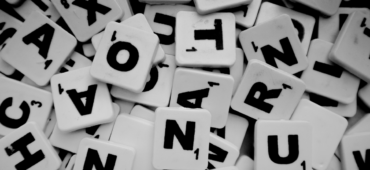 Black and white photo of a pile of scrabble tiles