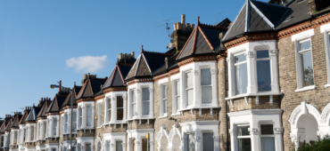 Photo of terraced houses beneath a blue sky