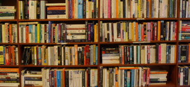 Photo of shelves crammed tight with books.