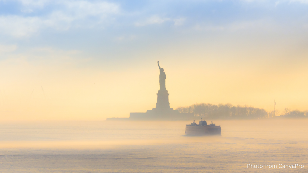 Photo of the statue of liberty surrounded by morning mist.