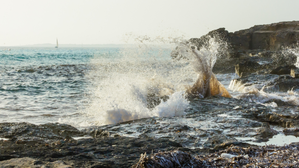 The sea splashing over rocks.