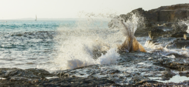 The sea splashing over rocks.
