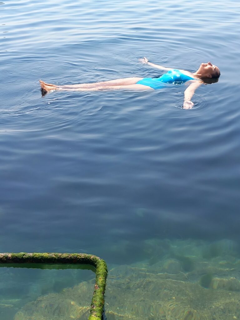 Katrina Naomi floating on her back in the sea off Battery Rocks
