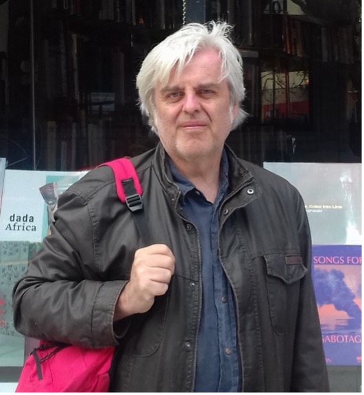 Photo of Nick Freeman standing outside a shop window