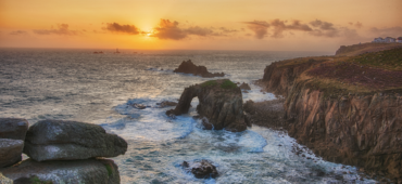 Photo of the golden sky over a foamy sea