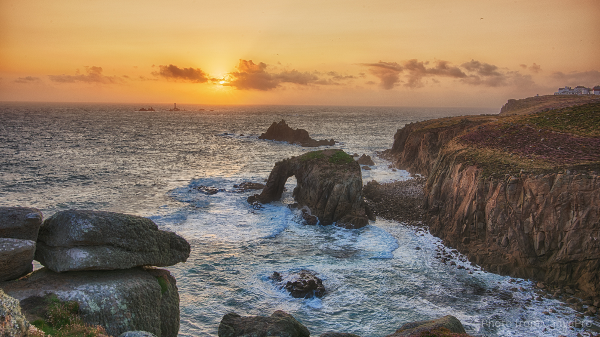 Photo of the golden sky over a foamy sea