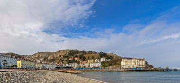 Photo of Llandudno seafront taken from the pebbled beach.