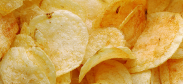 Close up photo of a pile of golden crisps