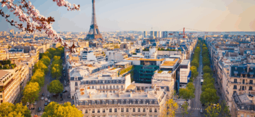 Photo of Paris looking across the city towards the Eiffel Tower in the distance.