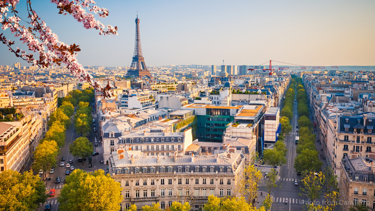Photo of Paris looking across the city towards the Eiffel Tower in the distance.