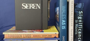 Photo of the 10 books in the prize draw bundle and one of our soft-touch notebooks
