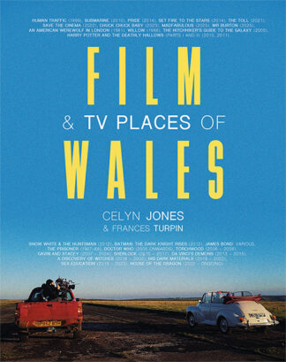 This cover shows a wide shot image of people in a truck filming a white car driving into the distance beneath a bright blue sky. The text reads Film & TV Places of Wales. Celyn Jones and Frances Turpin.