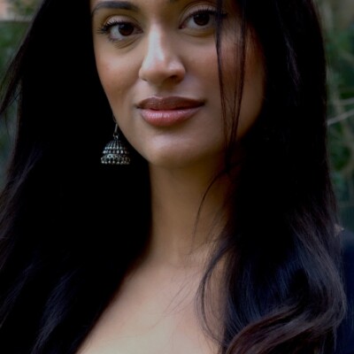 Photo of Rupinder Kaur Waraich standing outside.