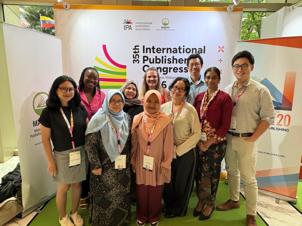 Photo of the British Council group standing in front of the IPA congress logo