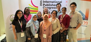 Photo of the British Council group standing in front of the IPA congress logo