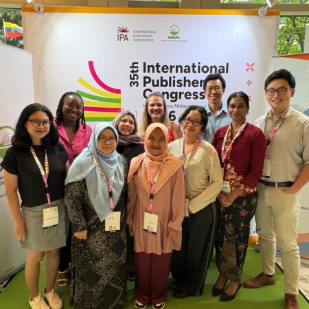 Photo of the British Council group standing in front of the IPA congress logo